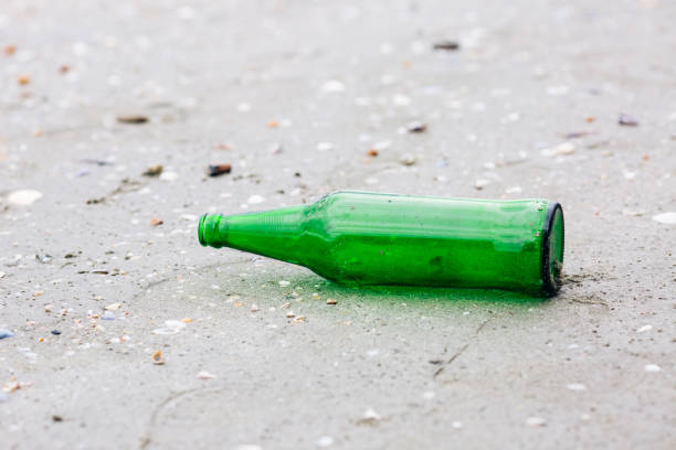 istock Green glass bottles were left on the beach. 852853886