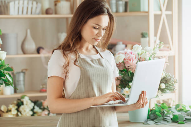 istock Young woman florist occupation working with flowers 852862354