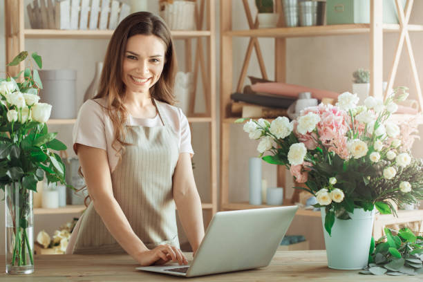 istock Young woman florist occupation working with flowers 852862436