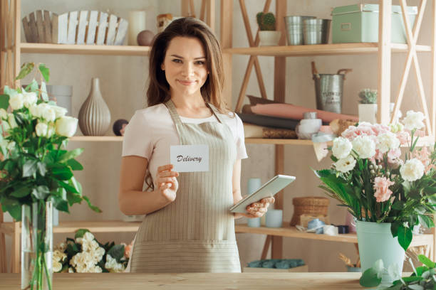 istock Young woman florist occupation working with flowers 852862634