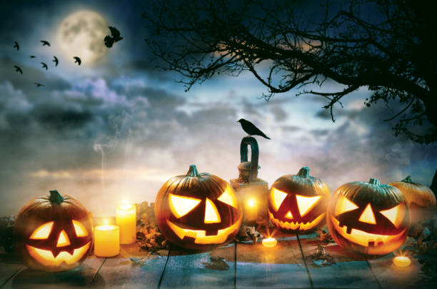 istock Spooky halloween pumpkins on wooden planks 852862636