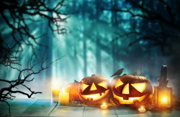 istock Spooky halloween pumpkins on wooden planks 852862710