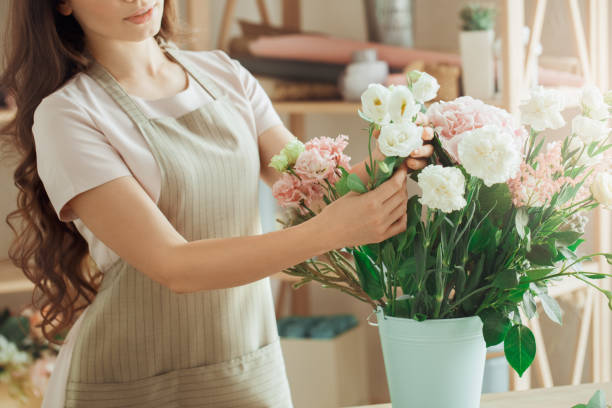 istock Young woman florist occupation working with flowers 852862730