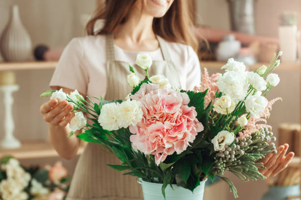 istock Young woman florist occupation working with flowers 852863140