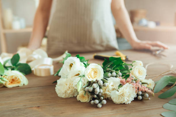 istock Young woman florist occupation working with flowers 852869132