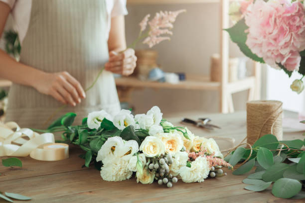 istock Young woman florist occupation working with flowers 852869204