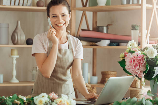 istock Young woman florist occupation working with flowers 852870076
