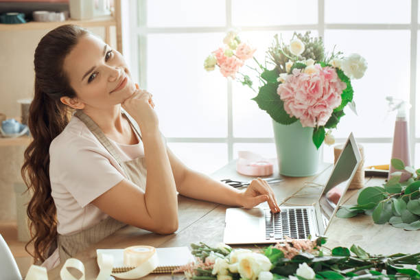 istock Young woman florist occupation working with flowers 852871620