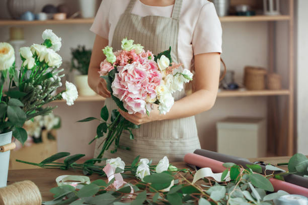 istock Young woman florist occupation working with flowers 852872028