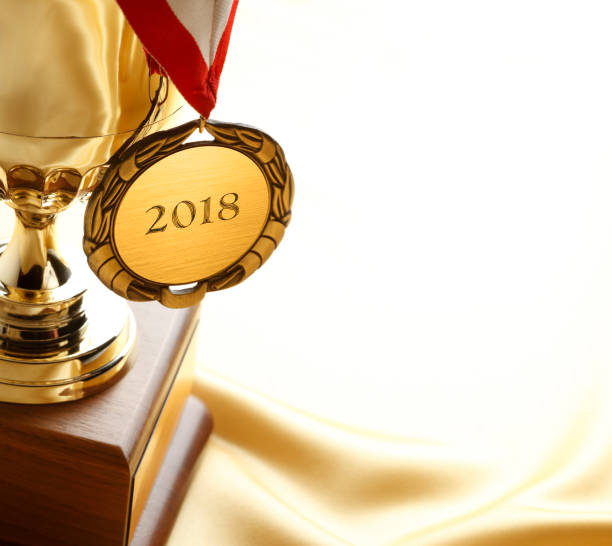 istock Gold Medal and Trophy Engraved With 2018 852872202