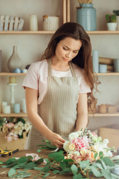 istock Young woman florist occupation working with flowers 852872456