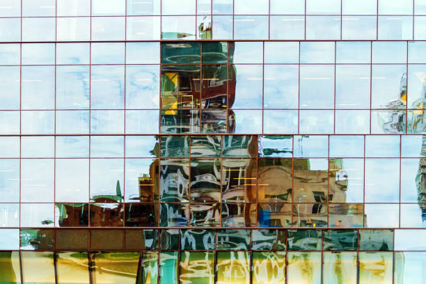istock Buildings reflected with distortion on glazed wall of office tower 852872658