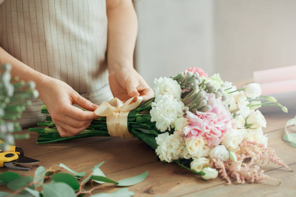 istock Young woman florist occupation working with flowers 852872798