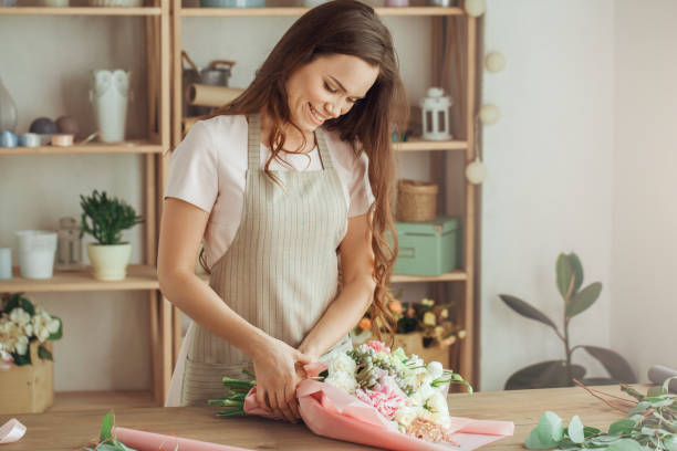 istock Young woman florist occupation working with flowers 852873150