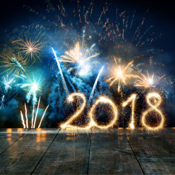 istock Sparkler New Year 2018 With Fireworks On Wooden Floor 852885980