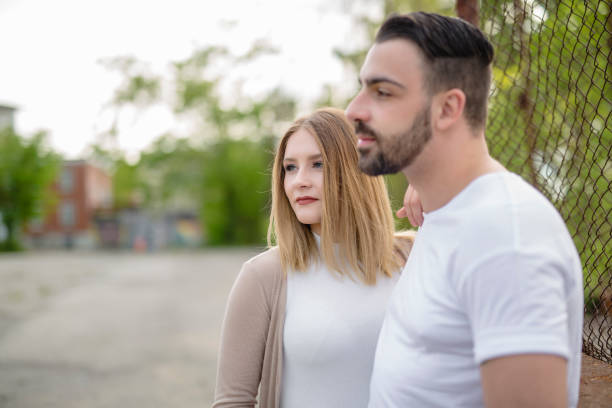 istock Couple close to a fence in a day 852890290