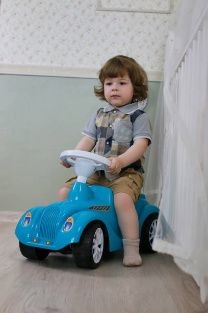 istock litle boy sit on a toy car 852903984