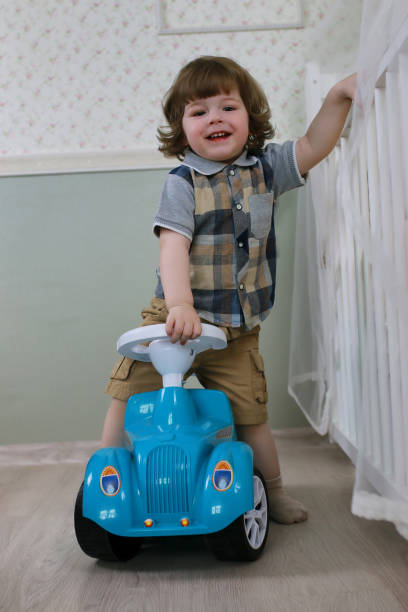 istock litle boy sit on a toy car 852904016