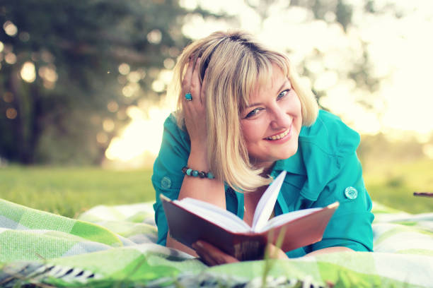 istock woman lay and read book sun 852905672