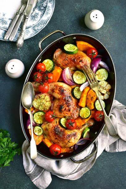 istock Chicken legs roasted with vegetables in a skillet pan 852913438