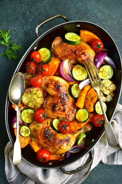 istock Chicken legs roasted with vegetables in a skillet pan 852913444