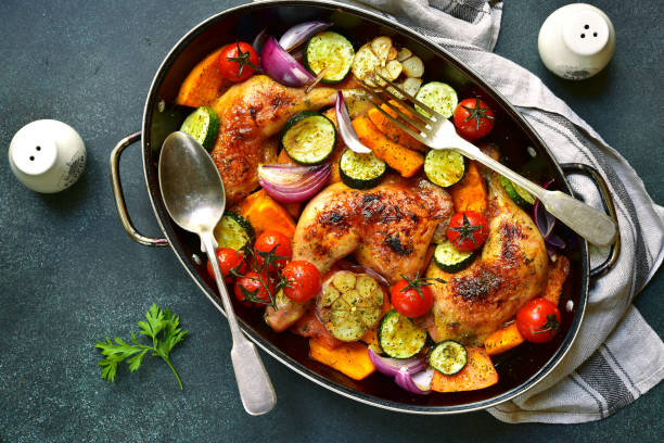 istock Chicken legs roasted with vegetables in a skillet pan 852913590