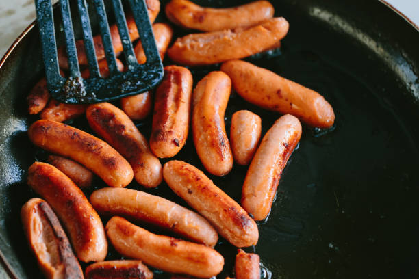 istock Fried sausages in a frying pan 852913974