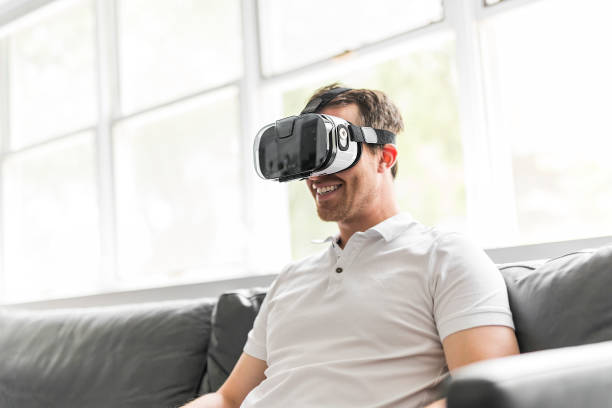 istock young man wearing virtual reality goggles in modern coworking studio 852934224