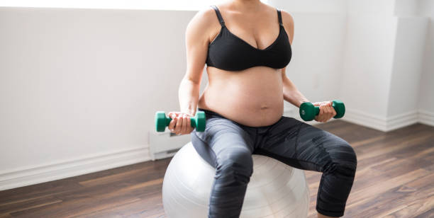 istock Pregnant woman training with dumbbells to stay active 852938670
