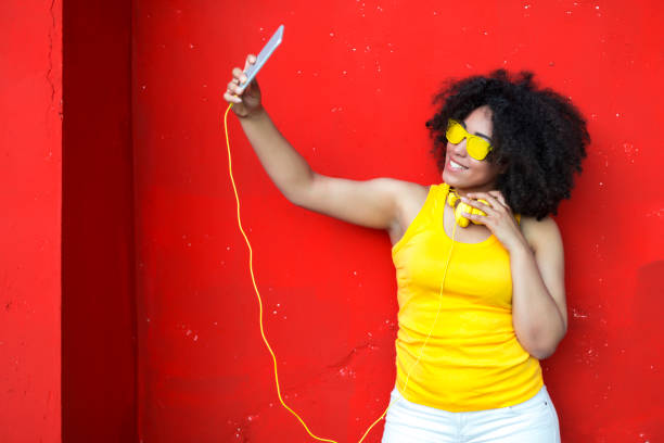 istock Woman with  yellow sunglasses taking selfie 852939582