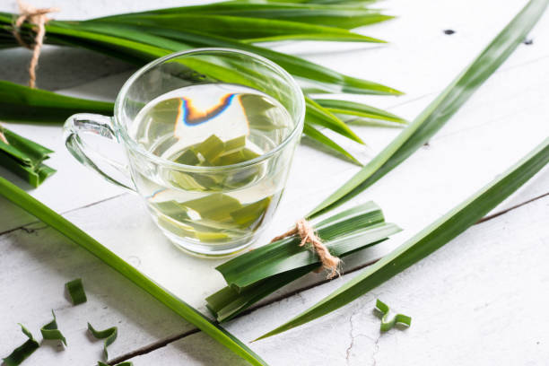 istock Fresh Fragrant Pandan Tea and leaves on wood background 852940032