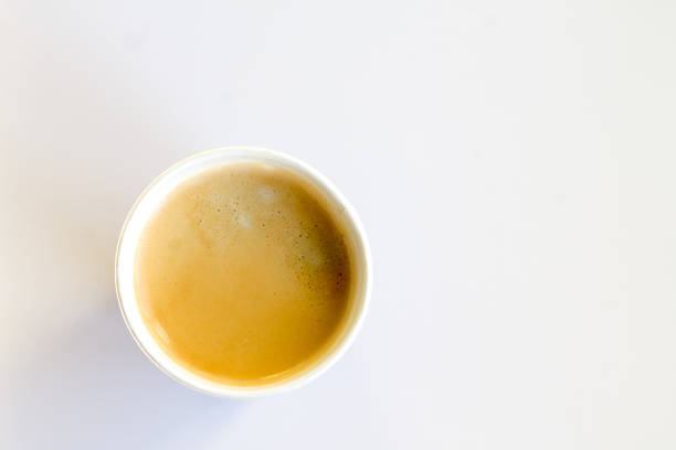 istock Coffee to go with foam in a paper cup on a white background 852945016