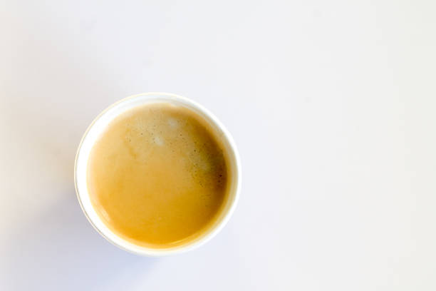istock Coffee to go with foam in a paper cup on a white background 852945042