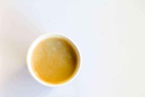 istock Coffee to go with foam in a paper cup on a white background 852945070