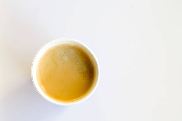 istock Coffee to go with foam in a paper cup on a white background 852945150