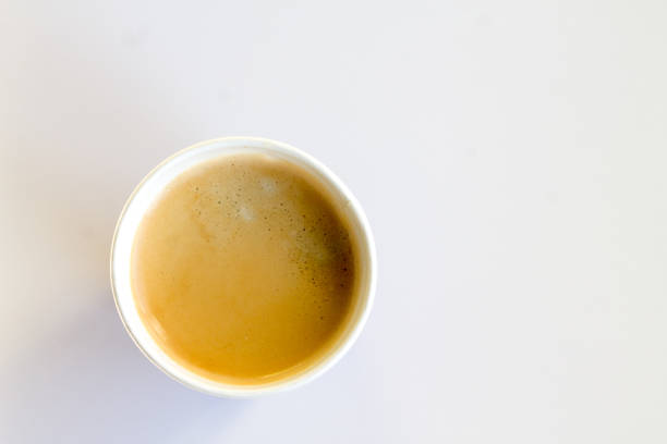 istock Coffee to go with foam in a paper cup on a white background 852945240