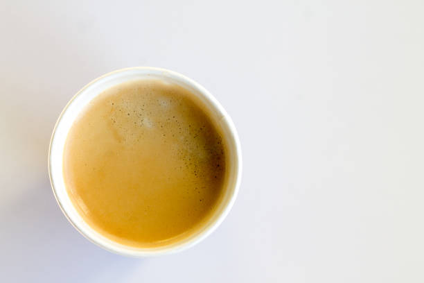 istock Coffee to go with foam in a paper cup on a white background 852945374