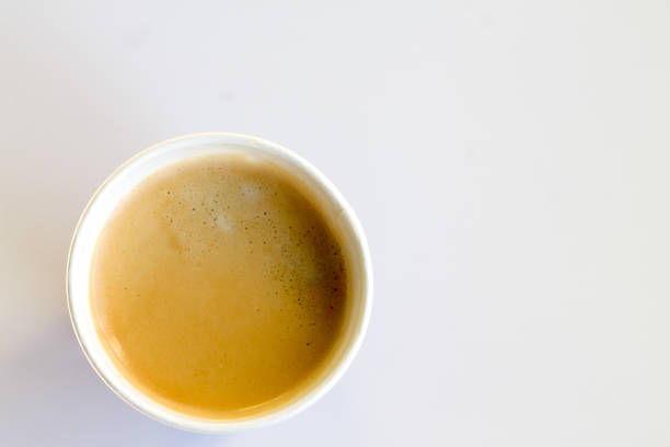 istock Coffee to go with foam in a paper cup on a white background 852945478