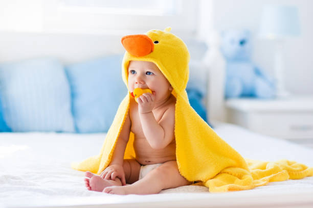 istock Cute baby after bath in yellow duck towel 852949544