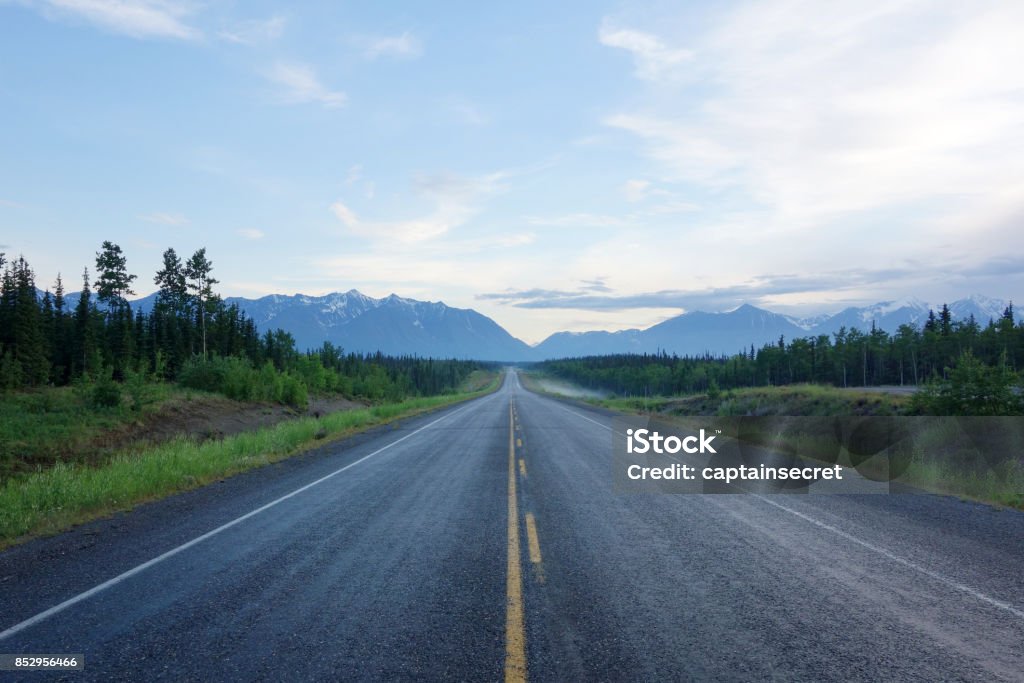 Centre of a long deserted Alaska Highway Shot from the centre of a long straight deserted stretch of Alaska Highway in Kluane National Park, Yukon Territory, Canada. Road Stock Photo