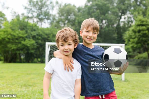 Two Brothers Having Fun Playing With Ball Stock Photo - Download Image Now - Child, Soccer, Boys