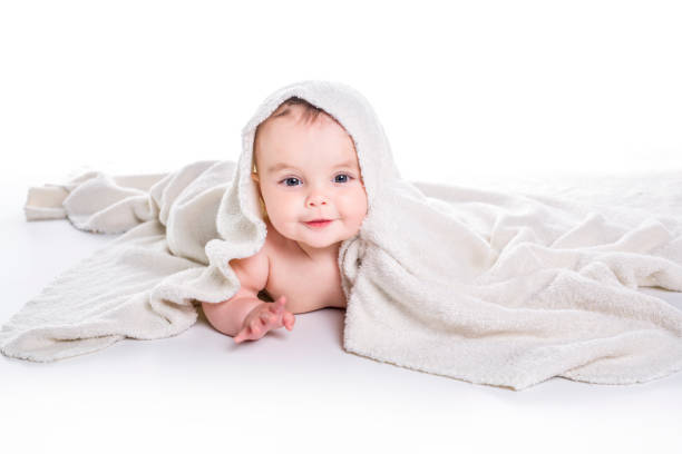 istock baby under a towel. isolated on a white background 852973208