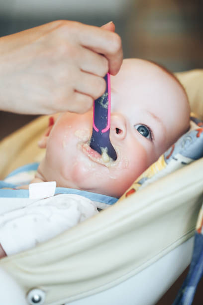 istock Infant Baby Child Boy Six Months Old is Eating 852978580