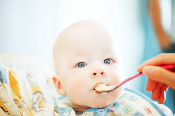 istock Infant Baby Child Boy Six Months Old is Eating 852978614