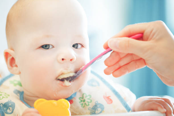 istock Infant Baby Child Boy Six Months Old is Eating 852978670