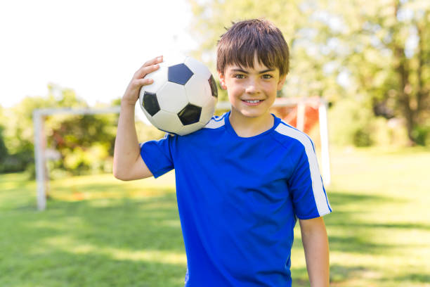 istock Young boy with soccer ball on a sport uniform 852983862