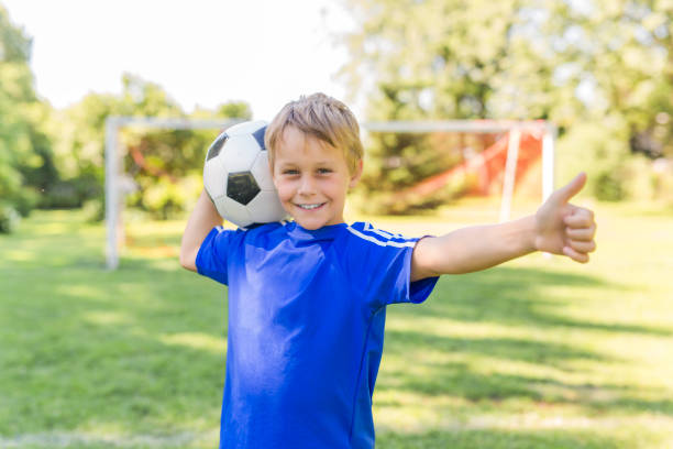 istock Young boy with soccer ball on a sport uniform 852985010
