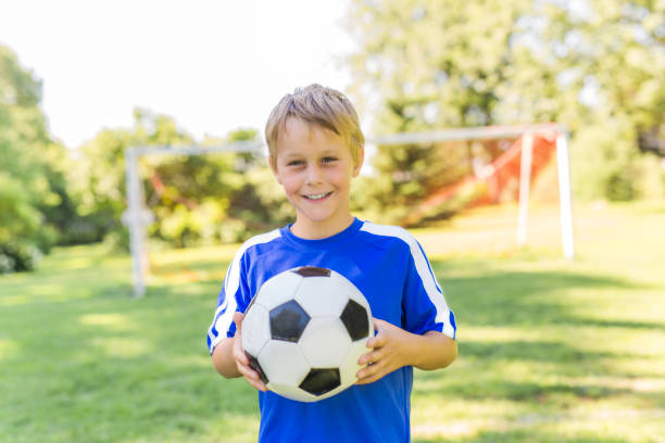 istock Young boy with soccer ball on a sport uniform 852985042