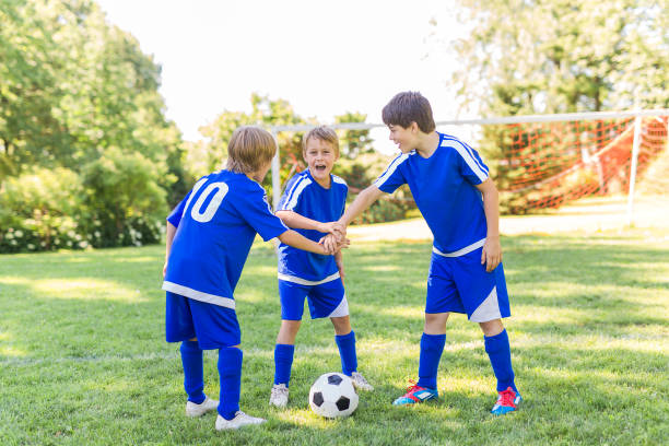 istock three, Young boy with soccer ball on a sport uniform 852985250