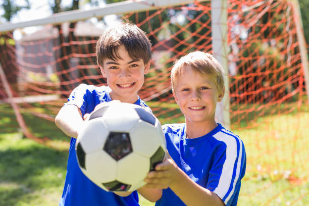 istock Two Young boy with soccer ball on a sport uniform 852985898